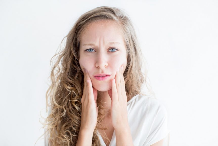 Woman worried about her face due to dry skin